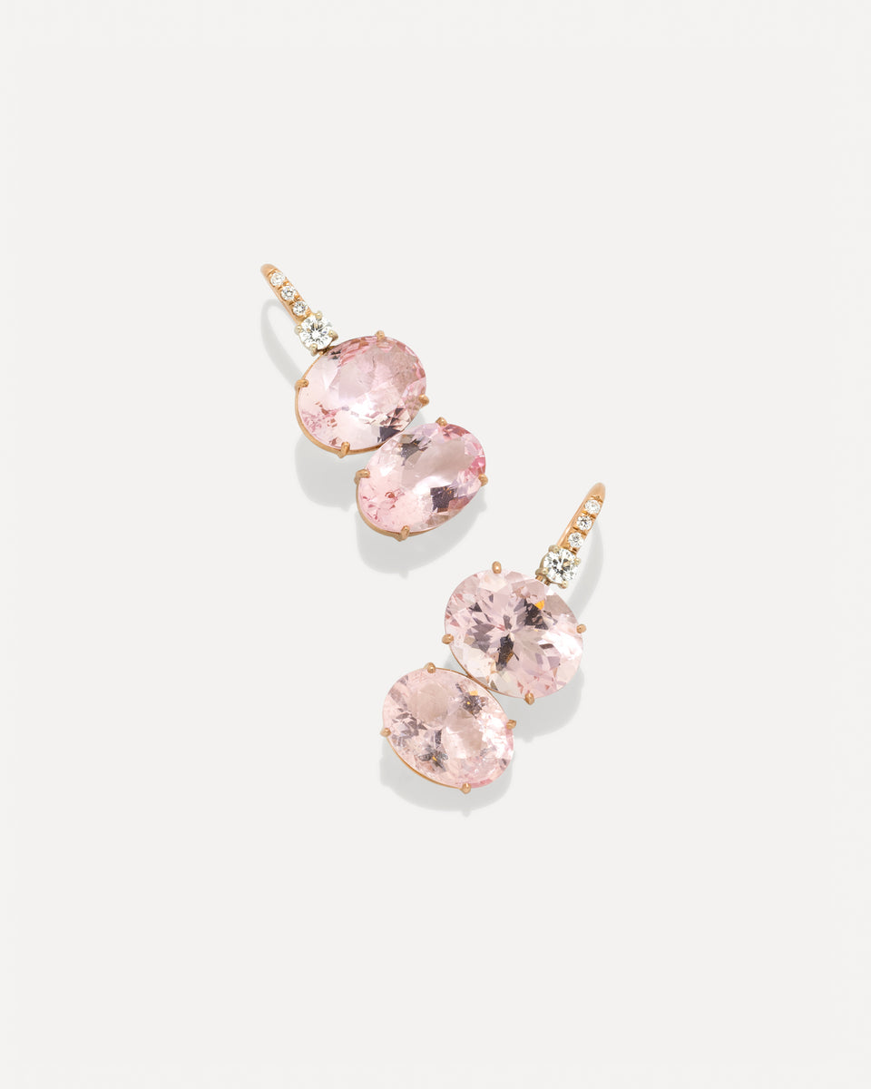 A pair of rose gold drop earrings featuring oval pink gemstones and small diamonds, displayed on a clean light gray background.
